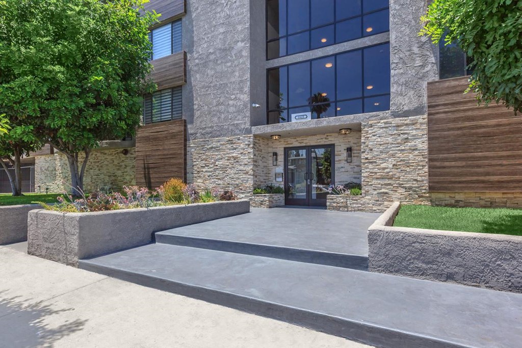 A modern building with a stone facade and a glass entrance at Lafayette Apartments, California