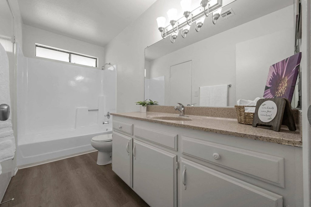 a white bathroom with a sink and a toilet