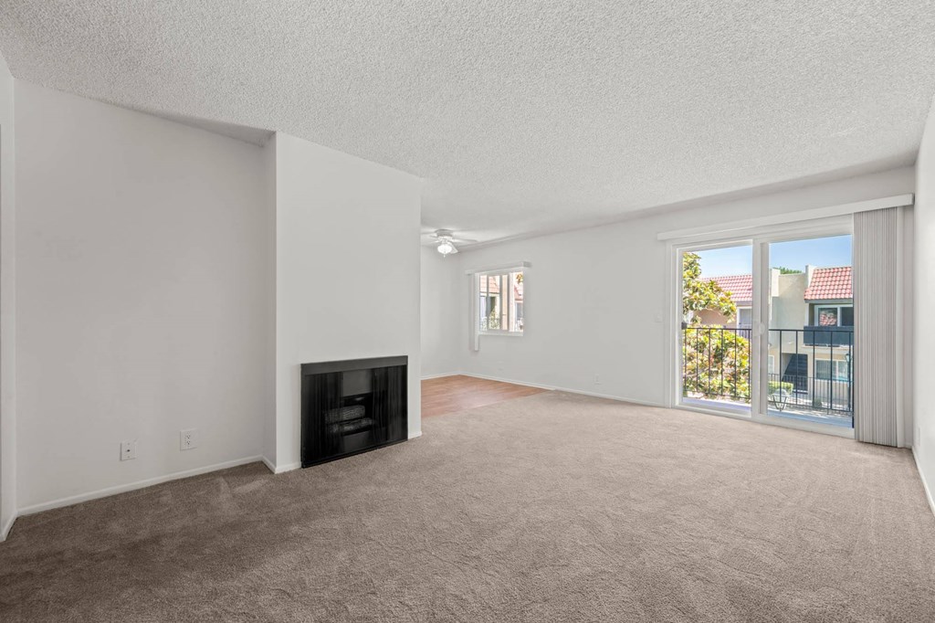 a living room with a fireplace and a large window