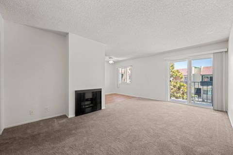 a living room with a fireplace and a large window