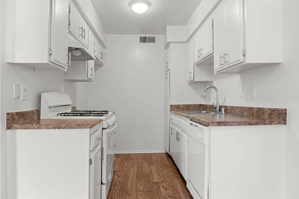 a kitchen with white cabinets and a counter top