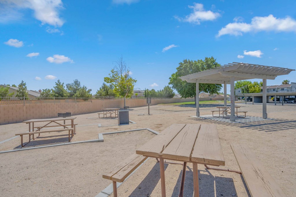 a picnic area with benches and picnic tables