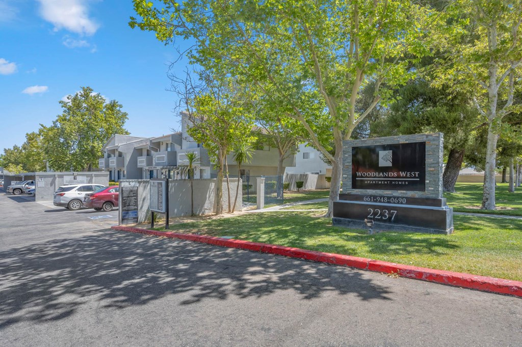a building with a sign in front of a parking lot