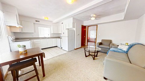 A kitchen with a table and chairs in the middle of the room.