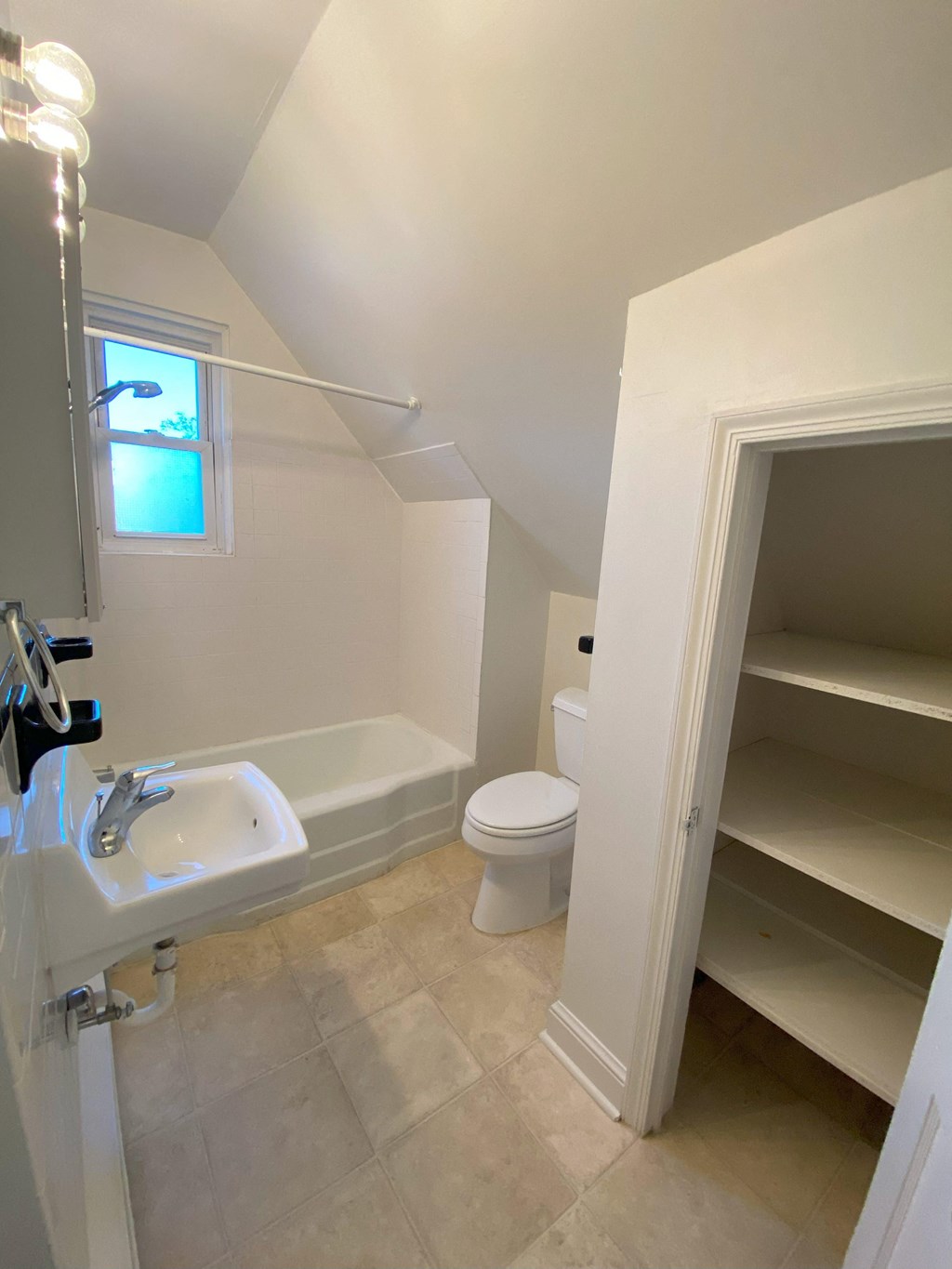 a small bathroom with a toilet sink and bathtub