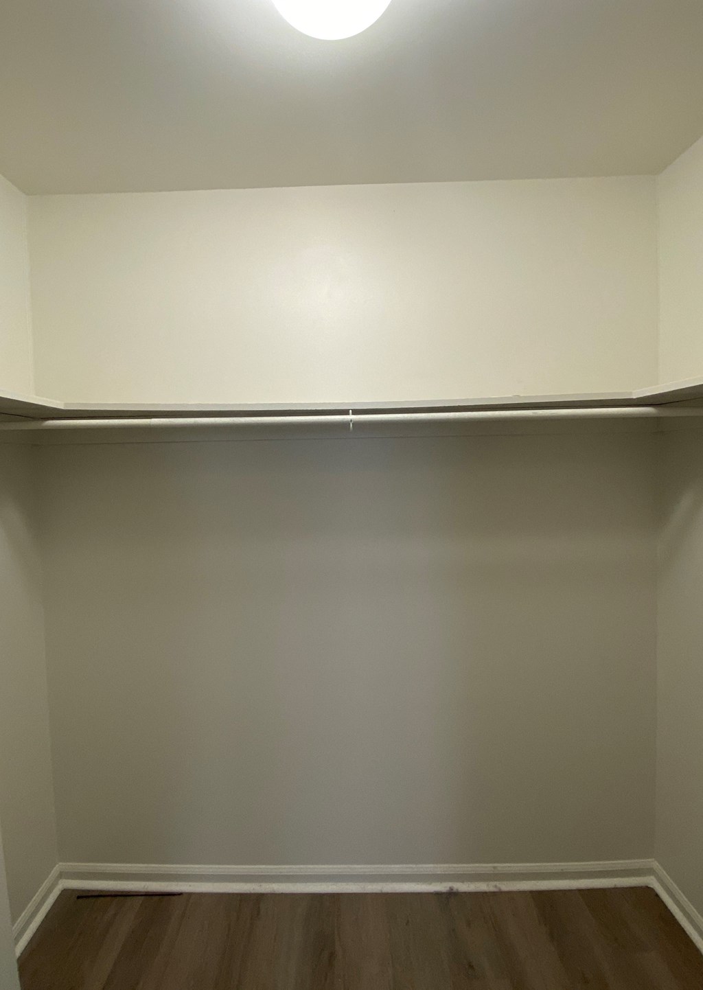 Courtside Apartments - 55+ Community - Master Bedroom Walk-in Closet / Wood-grain vinyl plank flooring