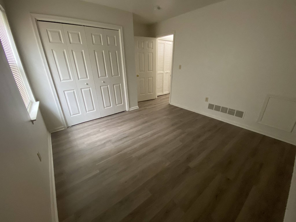 Courtside Apartments - 55+ Community - 2nd Bedroom / Closet / Wood-grain vinyl plank flooring