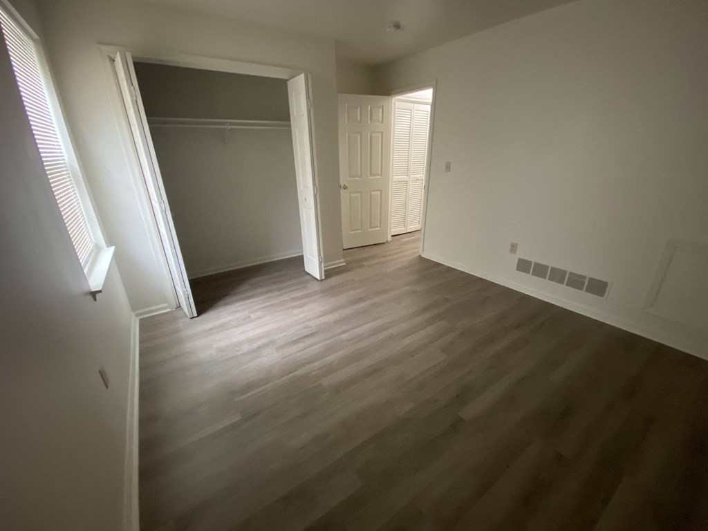Courtside Apartments - 55+ Community - 2nd Bedroom / Closet / Wood-grain vinyl plank flooring