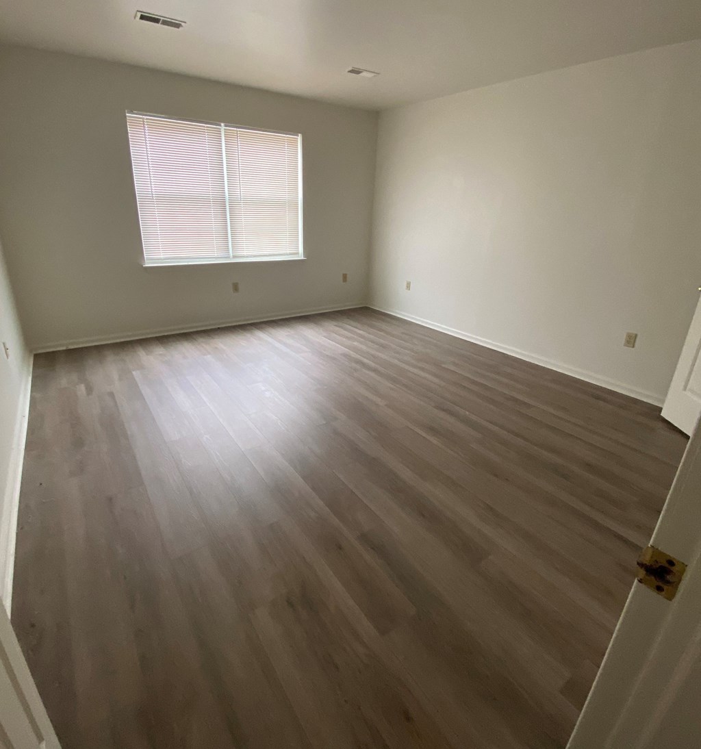 Courtside Apartments - 55+ Community - Bedroom / Wood-grain vinyl plank flooring