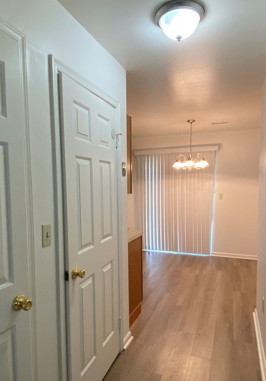 Courtside Apartments - 55+ Community - Hallway from Living Room to Eat-in Kitchen / Wood-grain vinly plank flooring