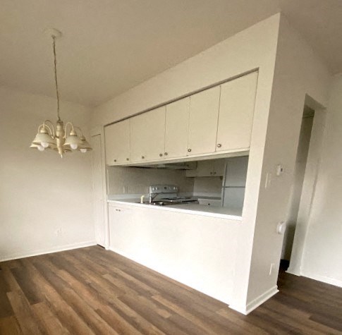 Governors Square Apartments - Dining Room / Pass-thru windo to Kitchen / Wood-grain vinyl plank flooring