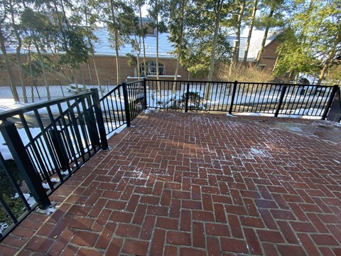 Kings Court Apartments - Front House - Large brick patio with black wrought iron railings