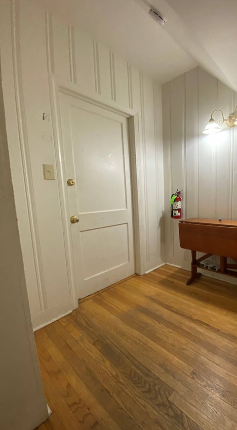 a room with a pool table and a door