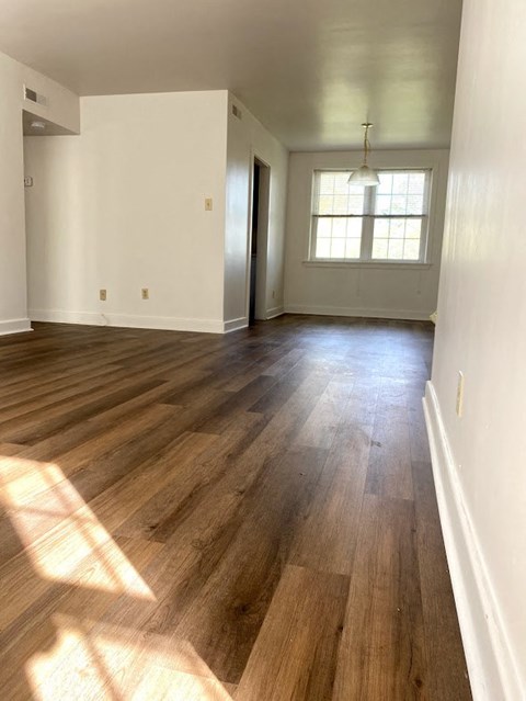 Garden Court Apartments - Living Room / Dining Room / Wood-grain vinyl plank flooring