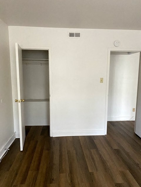 Garden Court Apartments - Bedroom / Closet / Wood-grain vinyl plank flooring