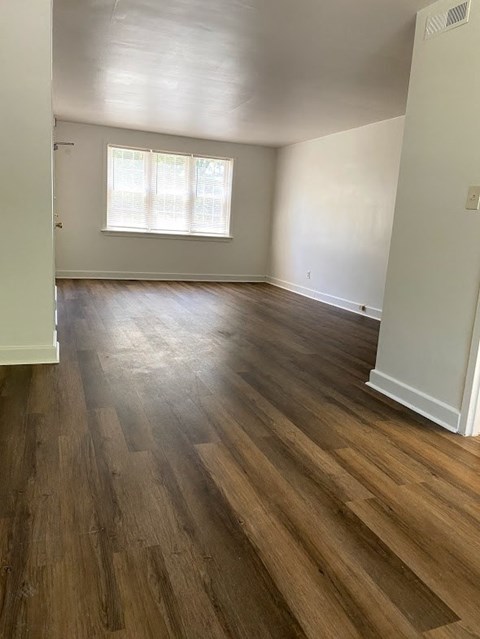 Garden Court Apartments - Living Room / Dining Room / Wood-grain vinyl plank flooring