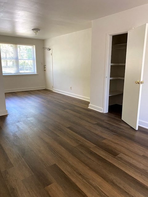Garden Court Apartments - Living Room / Dining Room / Wood-grain vinyl plank flooring