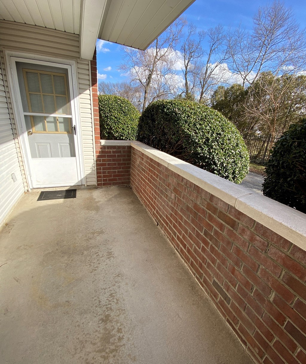 Kings Court Apartments - Main Building -  Patio with brick wall.