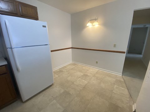 Kings Court Apartments - Main Building - Eat-in Kitchen / Refrigerator / Vinyl flooring