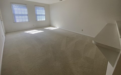 Kings Court Apartments - Main Building - Living room / Pass-thru to kitchen / Door to balcony / Wall-to-wall carpet