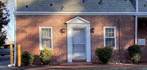 a red brick building with a blue door