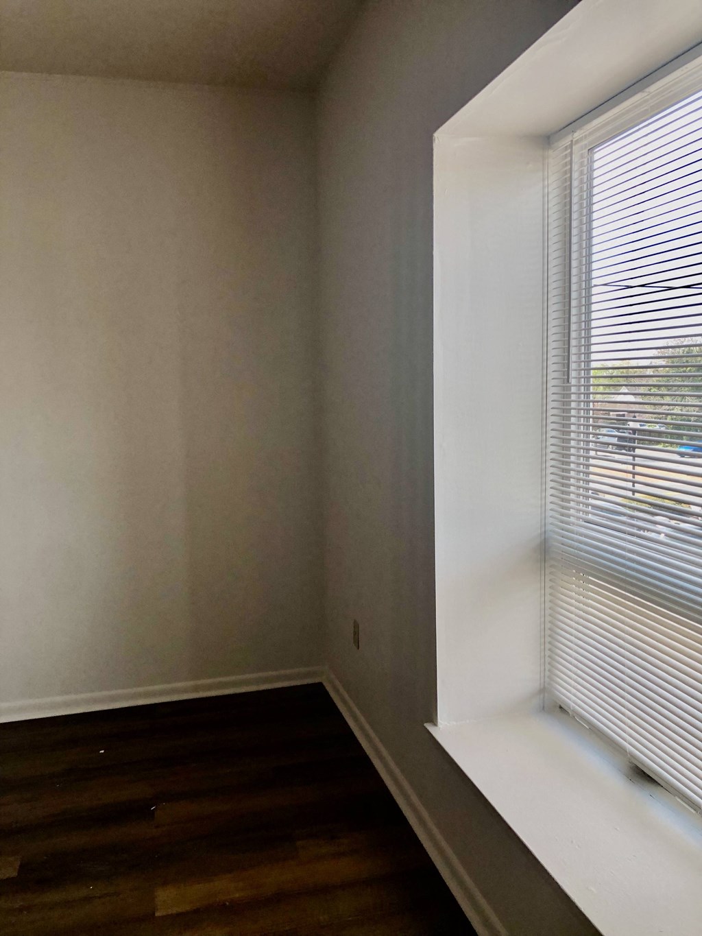 Loockerman Square Apartments - Over-size window ledge in living room / Wood-grain vinyl plank flooring