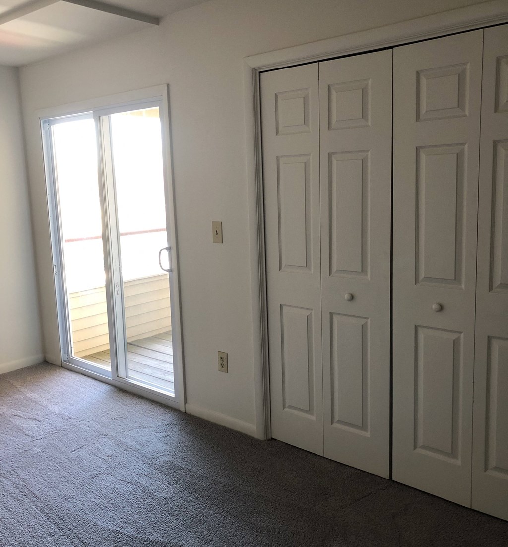 Loockerman Square Apartments - Bedroom with door to private balcony.