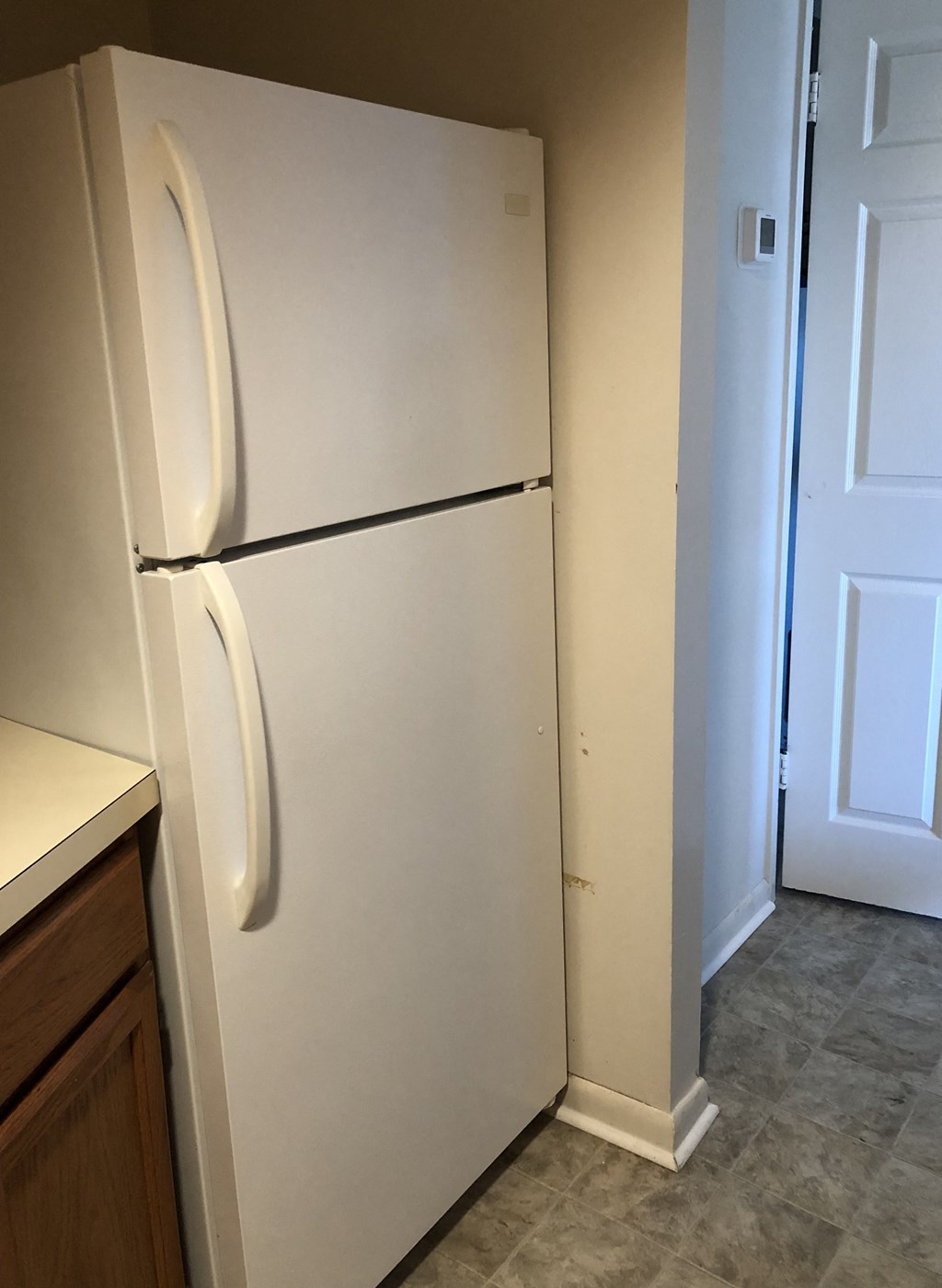 Loockerman Square Apartments - Kitchen with full-size refrigerator.