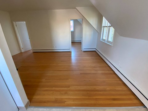 an empty room with a hardwood floor