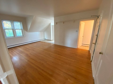 an empty room with a hardwood floor