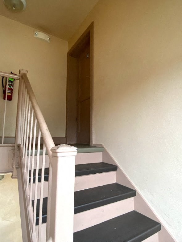 Mitten Apartments - Interior stairs with railing from entry to first floor apartments