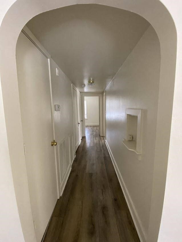 Mitten Apartments - Hallway from Living room to Bedrooms / Arched doorway / Wood-grain, vinyl plank flooring