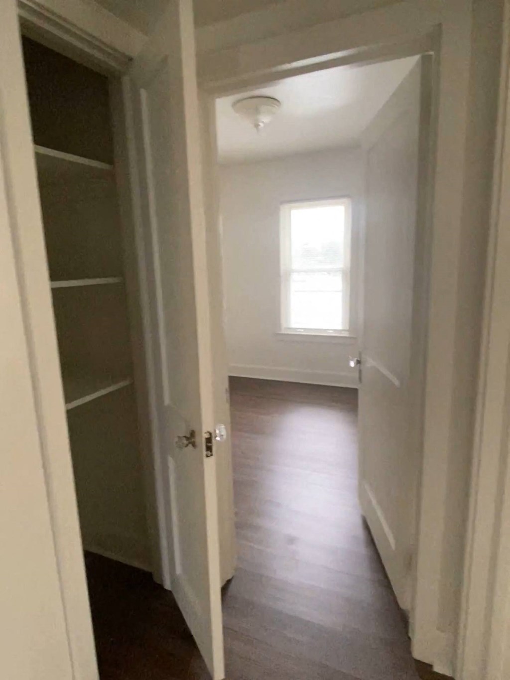 Mitten Apartments - Doorway to Bedroom / Linen Closet in Hallway / Wood-grain, vinyl plank flooring