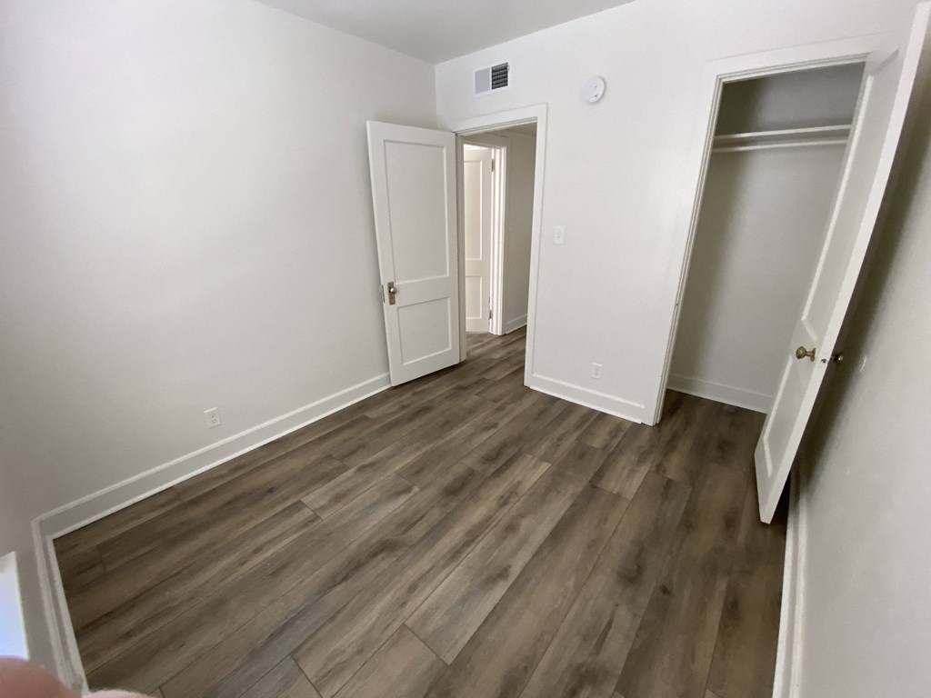 Mitten Apartments - Bedroom / Closet / Hallway to Living room / Wood-grain, vinyl plank flooring