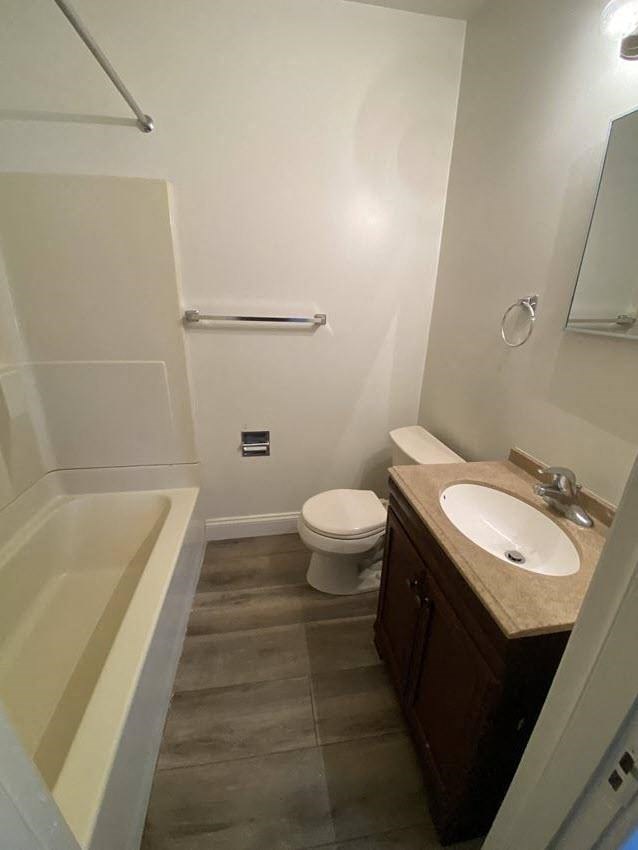 Mitten Apartments - Bathroom / Bathtub / Vanity / Mirror / Wood-grain, vinyl plank flooring