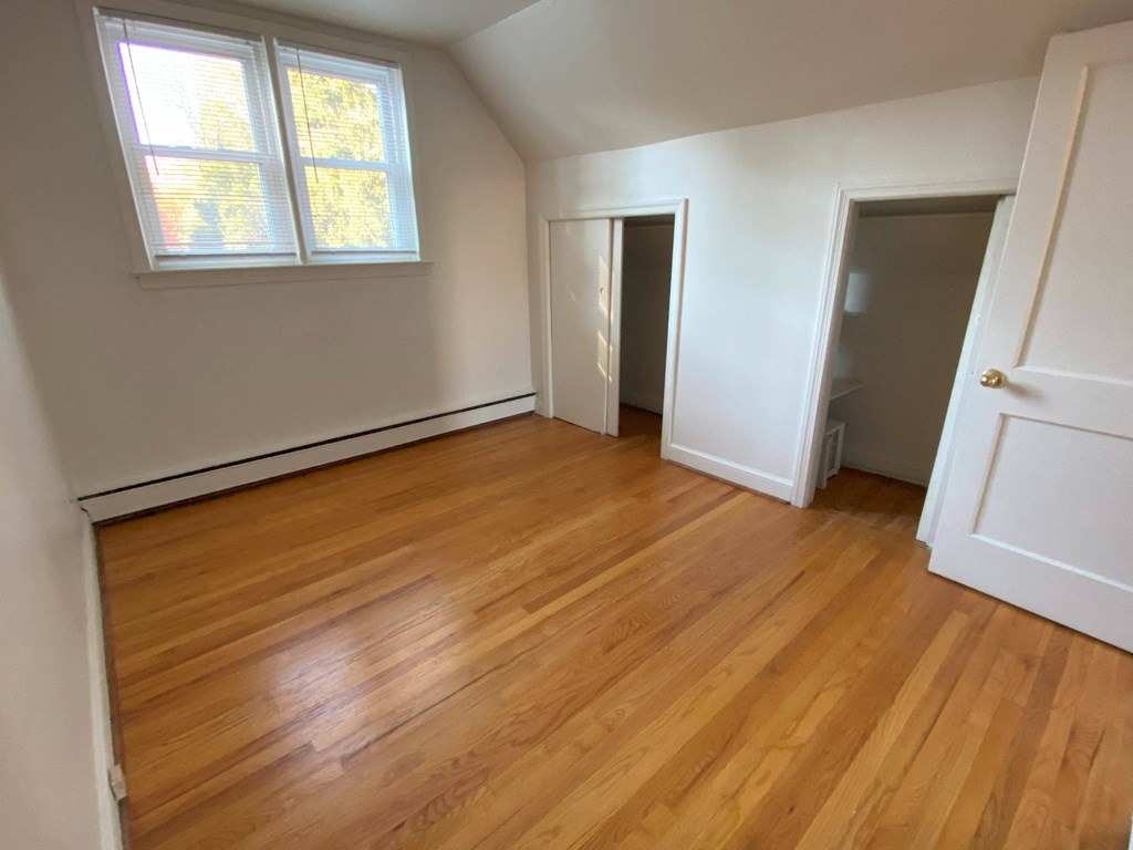 an empty room in a house with a wooden floor