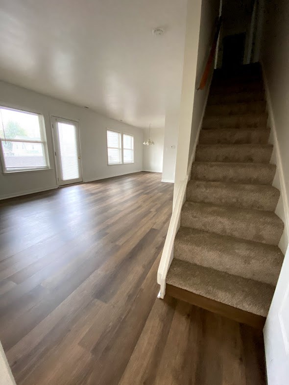 Governors Square Apartments - Stairs leading to second floor bedrooms / Living Room / Dining Room / Wood-grain vinyl plank flooring