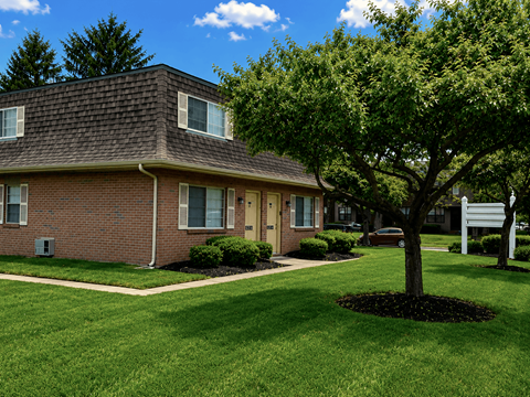 A house with a tree in front of it.