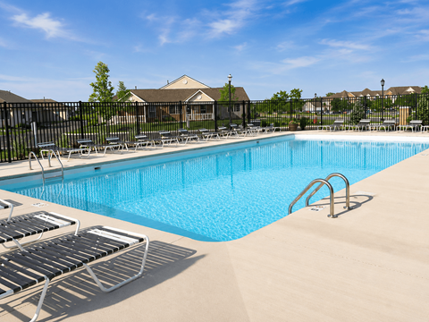 A large swimming pool surrounded by lounge chairs.