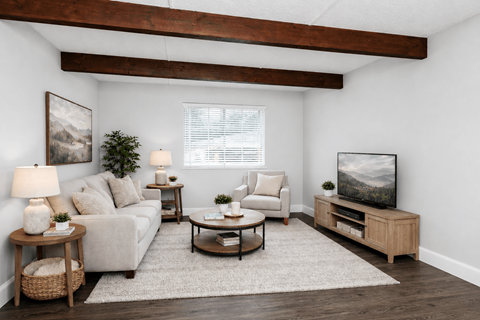 A living room with a couch, a coffee table, a lamp, and a painting on the wall.