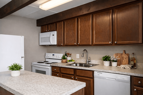 A kitchen with brown cabinets and a white fridge.