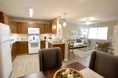 A kitchen with brown cabinets and a white refrigerator.