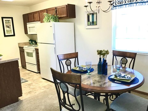 A kitchen with a table set for two.
