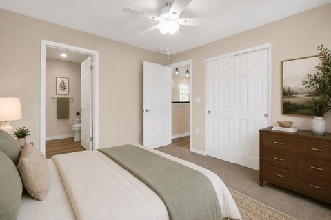 A bedroom with a bed, dresser, and mirror.