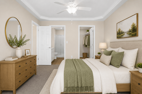 A bedroom with a bed, two nightstands and dresser in front of a closet and bathroom.