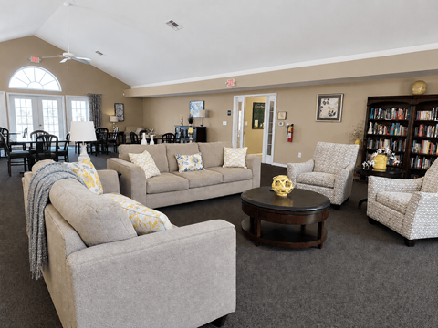 A living room with a grey couch and a coffee table.