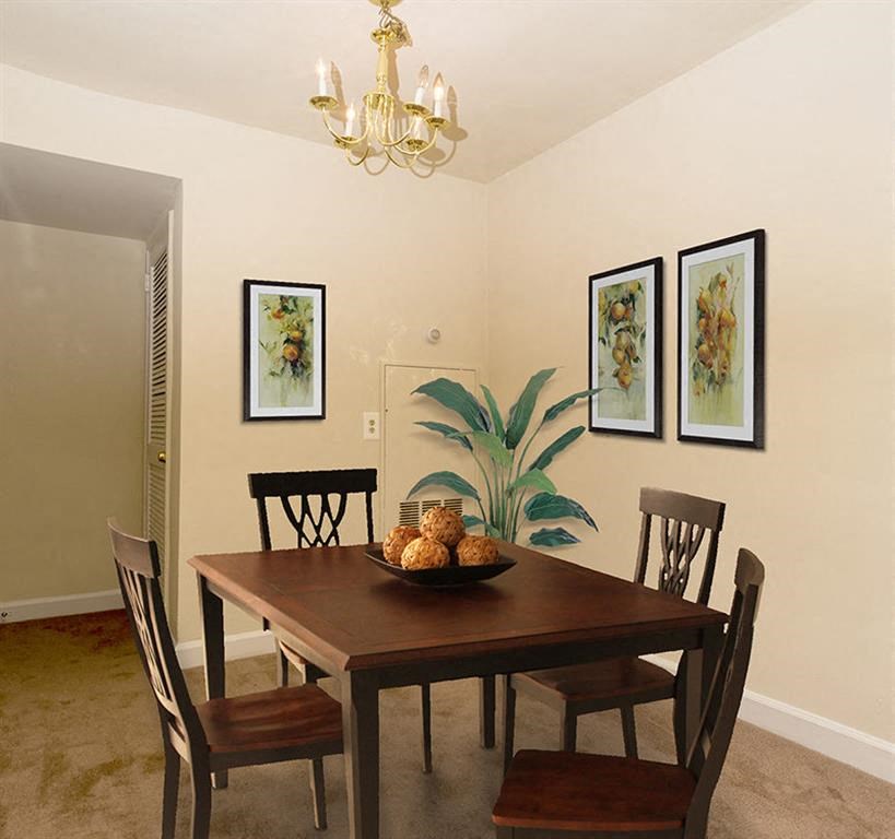 a dining room with a table and chairs