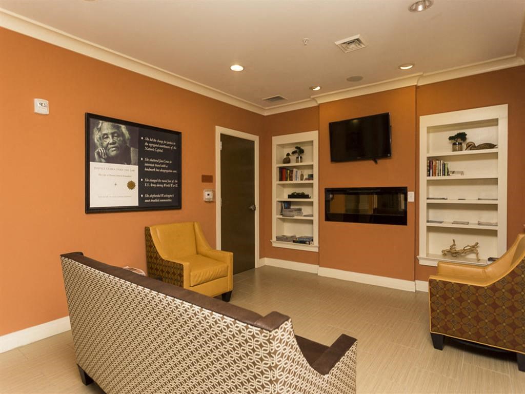 a waiting room with a couch and a tv