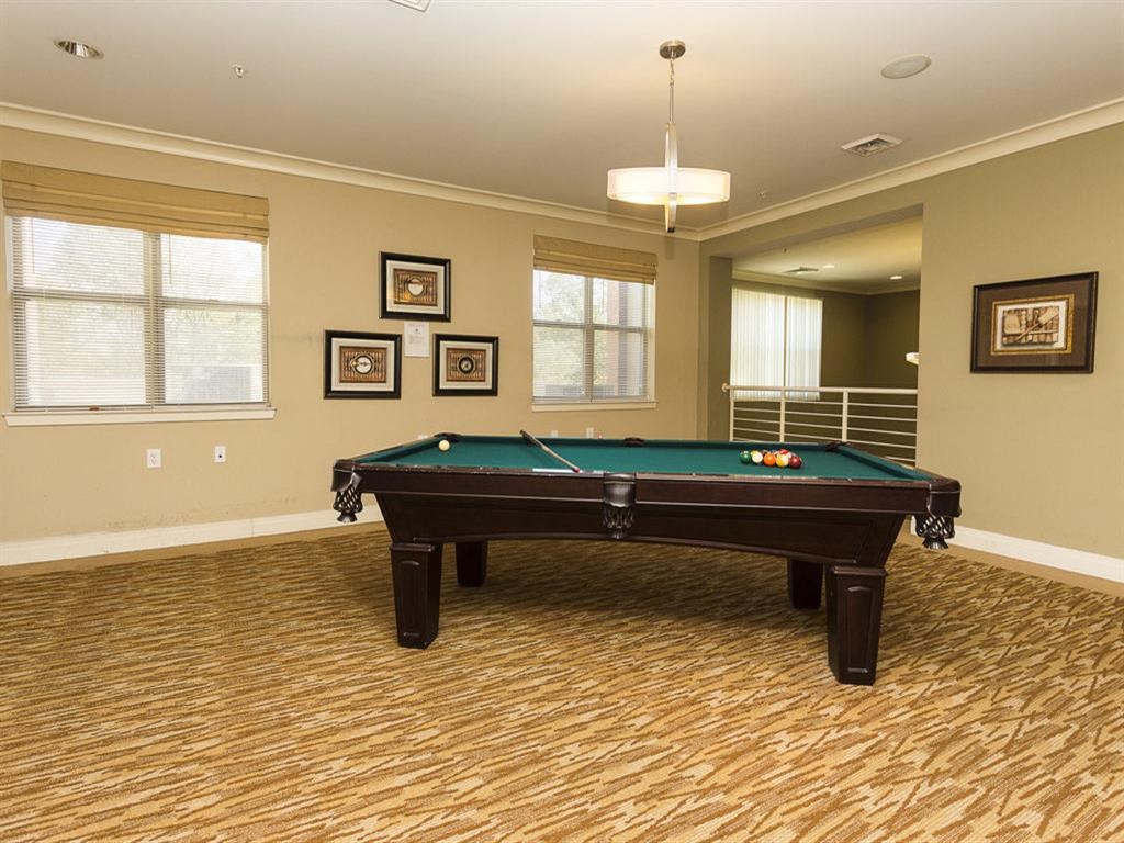 a game room with a pool table