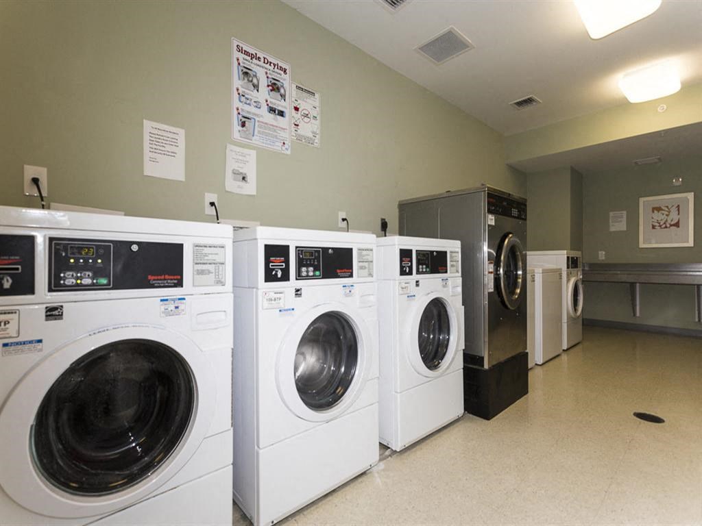 a group of washing machines in a laundromat